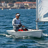 Man Sailing a Small Yacht in Blue Ocean Water