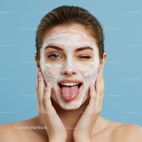 Young Woman Applying Facial Mask for Skincare and Beauty