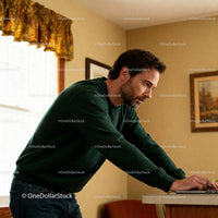 Focused man working on laptop in cozy home interior