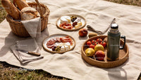 Rustic picnic with bread, cheese, fruit and cold drink
