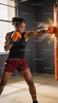 Focused athlete delivering a powerful punch on punching bag
