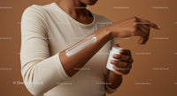 Close-up of Woman Applying Sunscreen Lotion on Arm for Skin Protection