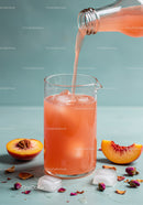 Refreshing Peach Juice Poured Over Ice in Glass Pitcher