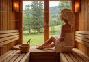 Woman Relaxing in Sauna with Scenic Mountain View and Wooden Interior