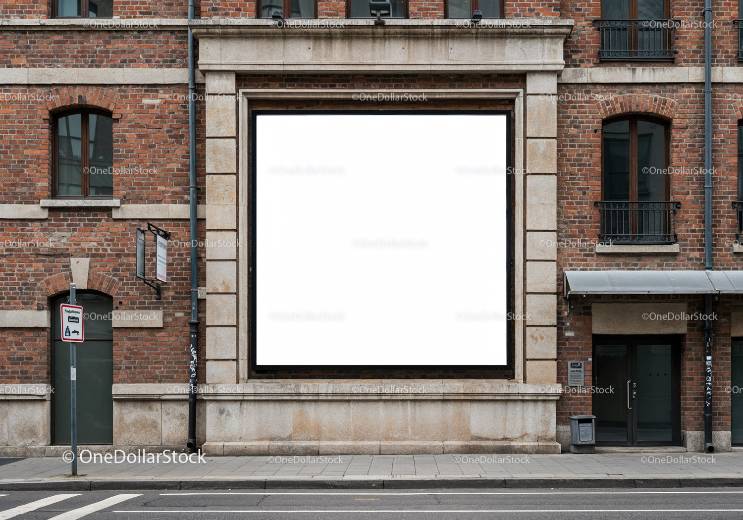 Blank square billboard on historic brick building facade