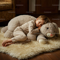 Little boy resting on giant plush bunny in cozy room