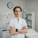 Professional Male Doctor Standing in Hospital Examination Room