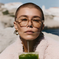 Fashionable Woman With Sunglasses Drinking Green Juice Outdoors