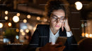 Focused Woman in Business Attire Using Smartphone in Night City Cafe