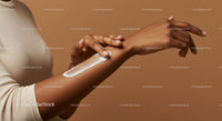 Close-Up of a Woman Applying Lotion on Hand for Skincare Routine