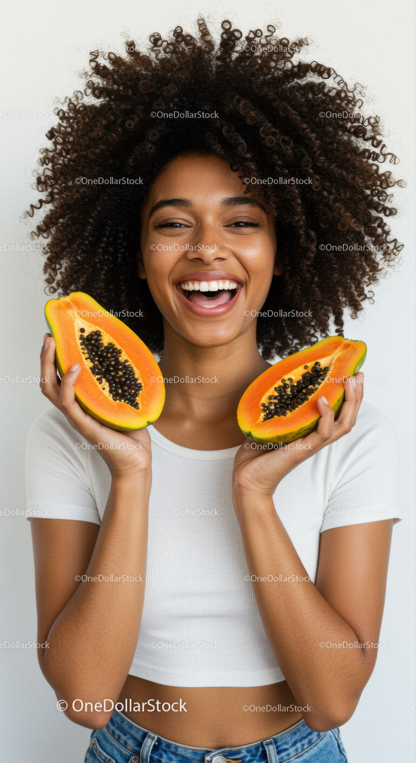 Joyful Woman Holding Slices of Fresh Papaya and Celebrating Life