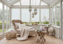 Cozy rattan lounge with soft blanket and crystal decor