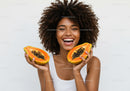 Vibrant Joyful Woman With Fresh Papaya Slices in Bright Studio