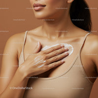 Close-up of Woman Applying Cream on Chest with Soft Skin in Neutral Tones