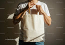 Man Holding Blank Beige Reusable Tote Bag