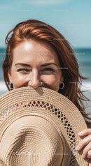 Smiling Woman with Straw Hat Enjoying Sunny Day at the Beach