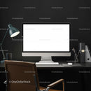 Modern workspace with blank computer screen and desk lamp