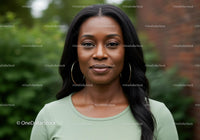 Confident woman posing outdoors with calm expression