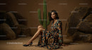 Elegant Model in Brown Suit Posing Amidst Desert Rocks