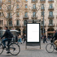 Blank urban billboard on busy city street with cyclists