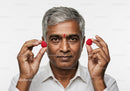 Senior Man Holding Raspberries Close-Up with Analysis of Fruit and Smile
