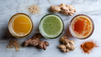 Refreshing Ginger and Turmeric Juices with Fresh Roots on Marble Surface