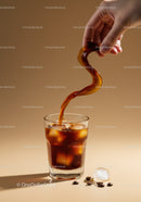 Hand Pouring Cold Brew Coffee with Ice Cubes
