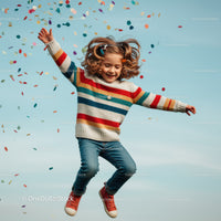 Joyful girl jumping with colorful confetti outdoors