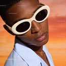 Stylish young man wearing white oval sunglasses