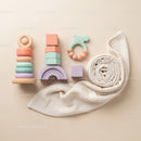 Neutral Toned Baby Toys and Soft Rolled Blanket