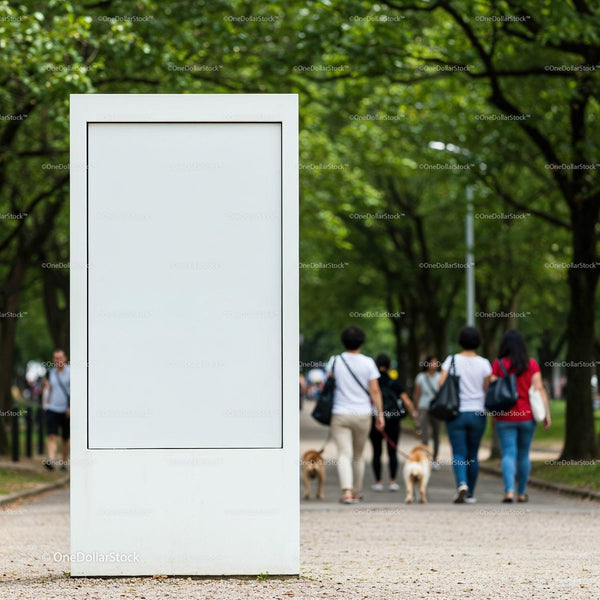 Blank white street billboard in green park alley JPG Mockup Image