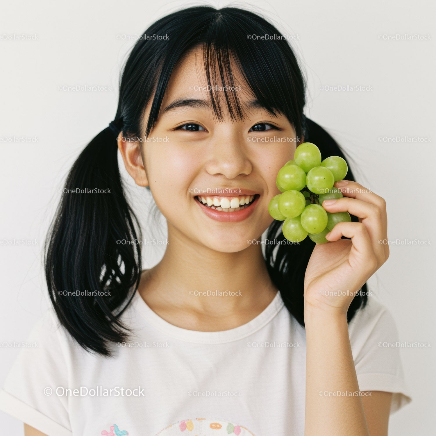Happy Girl Holding Fresh Green Grapes for Healthy Lifestyle