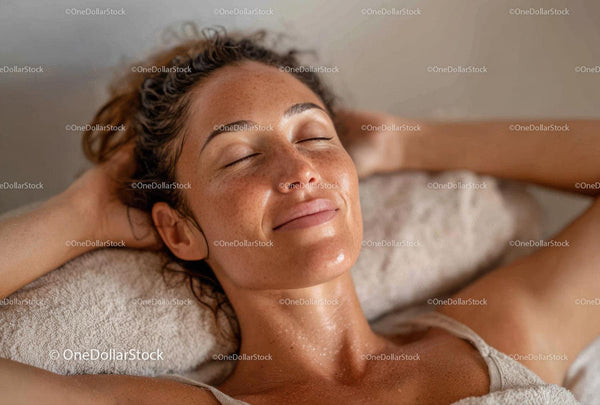 Relaxing Woman Receiving Facial Massage in Wellness Spa