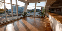 Bright Modern Cafe Interior with Large Windows and City View