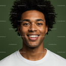 Close-Up of Smiling African American Man with Curly Hair on Green Background