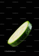 Fresh zucchini slice with water droplets on black background