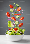 Fresh vegetable salad ingredients floating above bowl