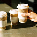 Hand Holding Takeaway Coffee Cup with Two Others Nearby