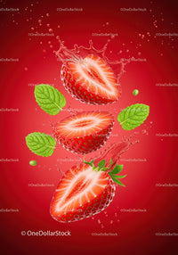 Fresh strawberry halves splashing in liquid with mint leaves