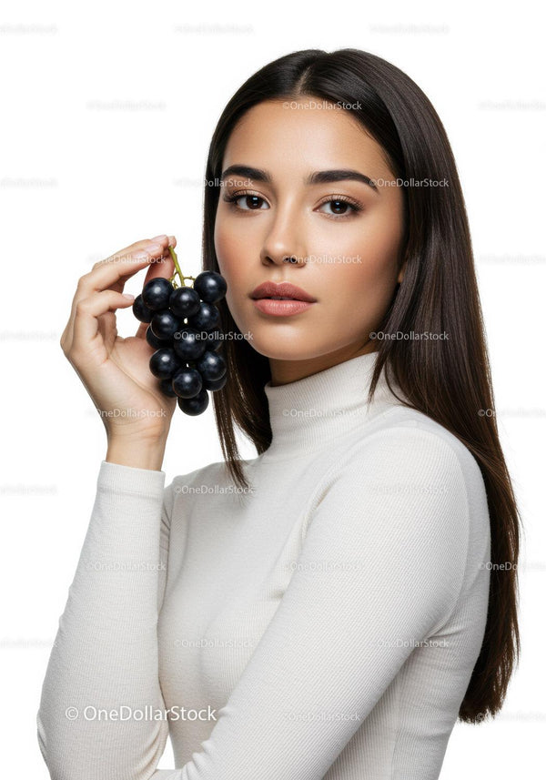 Elegant Woman Holding Clusters of Black Grapes in a Studio Portrait