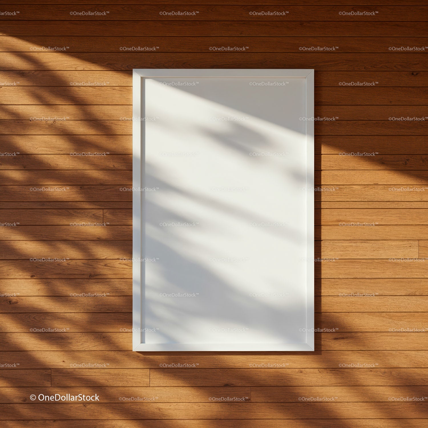 Empty white frame on warm wooden wall with shadows