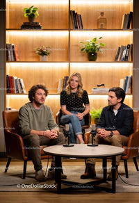 Three hosts engaged in podcast recording session