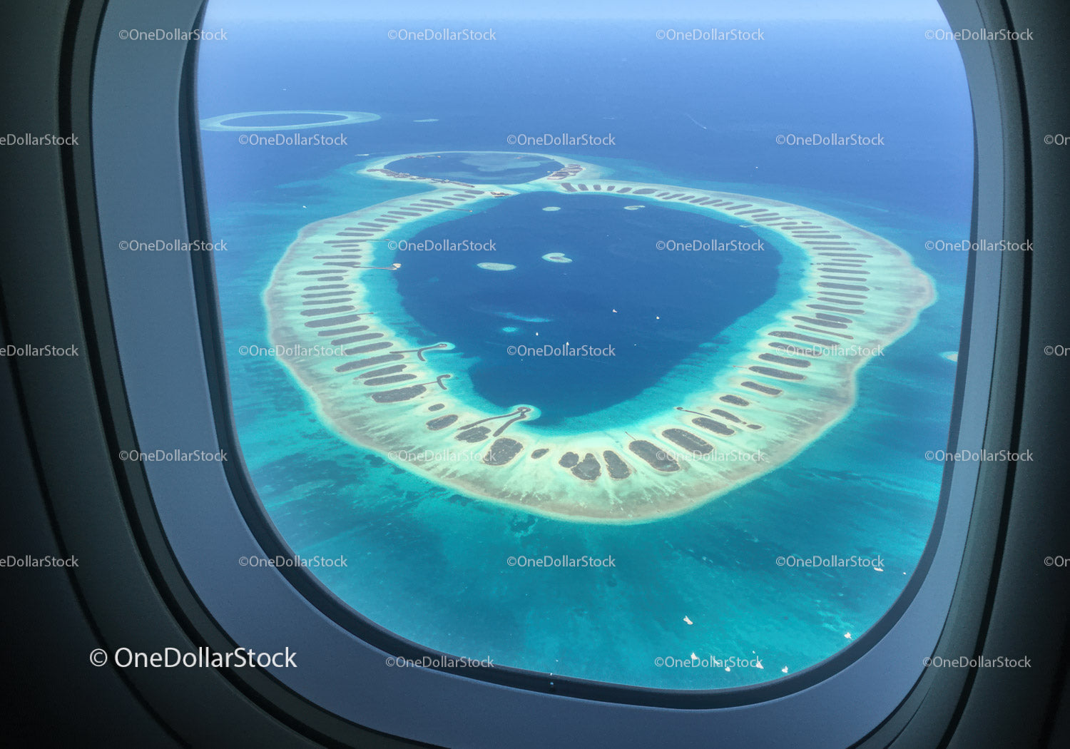 Aerial View of a Tropical Atoll Surrounded by Turquoise Ocean