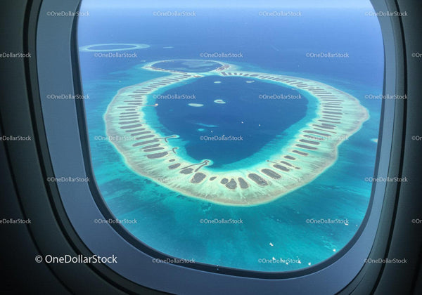 Aerial View of a Tropical Atoll Surrounded by Turquoise Ocean