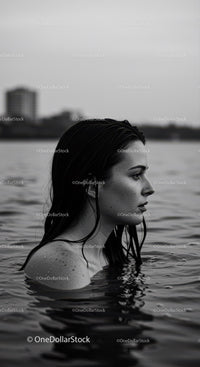 Serene Female Portrait in Water with Urban Background