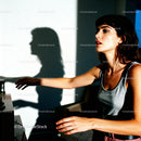 Young Woman Reaching Out with Dramatic Shadow Play