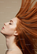 Profile of serene woman with flowing red hair