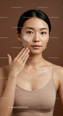 Young Asian Woman Applying Facial Moisturizer for Healthy Skin