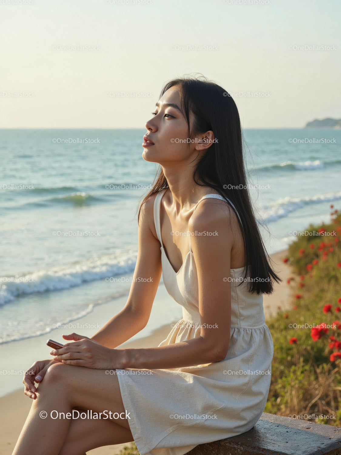 Elegant Woman in White Dress Sitting by Relaxing Seaside Landscape