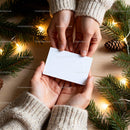 Hands exchanging blank card with Christmas decorations JPG Mockup Image preview